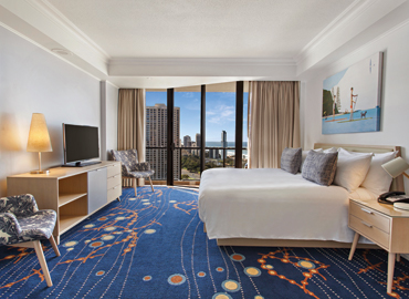 Interior of a spacious villa bedroom with window city view