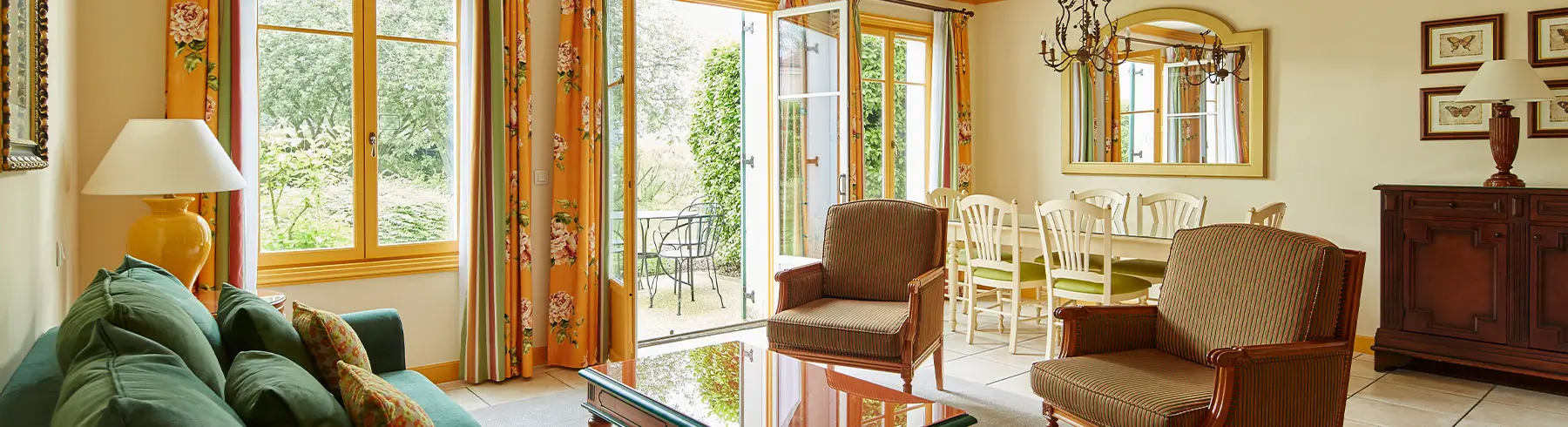 Cozy living room at Marriott’s Village d’Île-de-France with large windows and elegant decor.